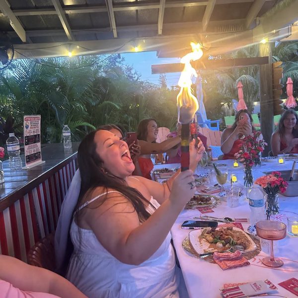 Guests enjoying a hibachi chef fire show at a private outdoor dinner party in Fort De Soto, Florida