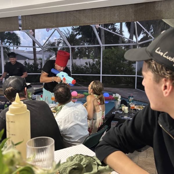 Guests watching a hibachi chef cook at the grill during a private dinner party on a screened patio in Fort De Soto, Florida