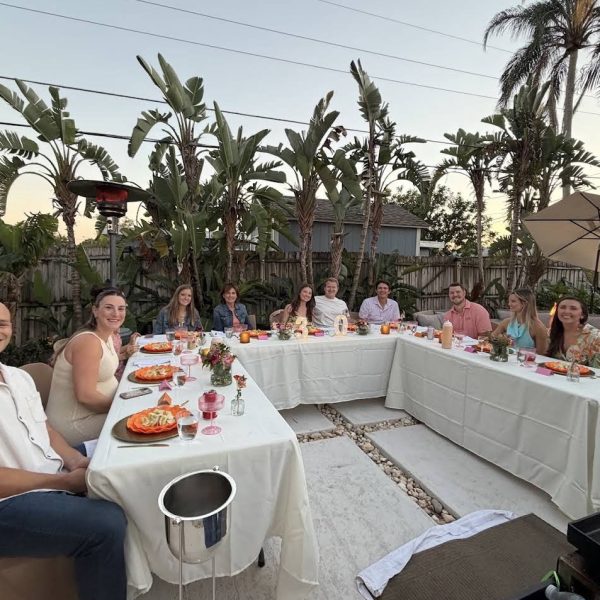 Large group of happy guests enjoying an outdoor hibachi dinner party in a backyard in Fort De Soto, Florida